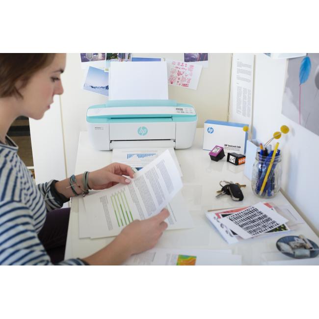 A girl printing a report on a HP DeskJet 3755 All-in-One using a HP Instant Ink Welcome Kit.