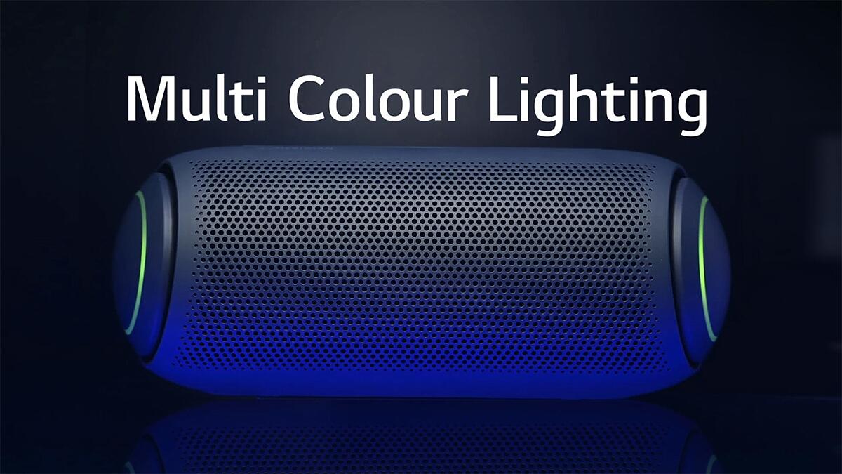 A front view of XBOOM Go with muli-coloured woofer lighting on a dark background