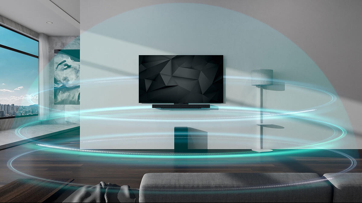 Blue dome-shaped, 3 layered sound wavers are covering Soundbar and TV hung on the wall in the living room.