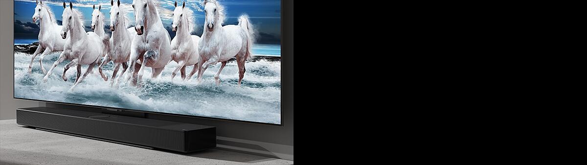 LG Soundbar and LG TV are placed on the white table and 7 white horses are shown on the TV.