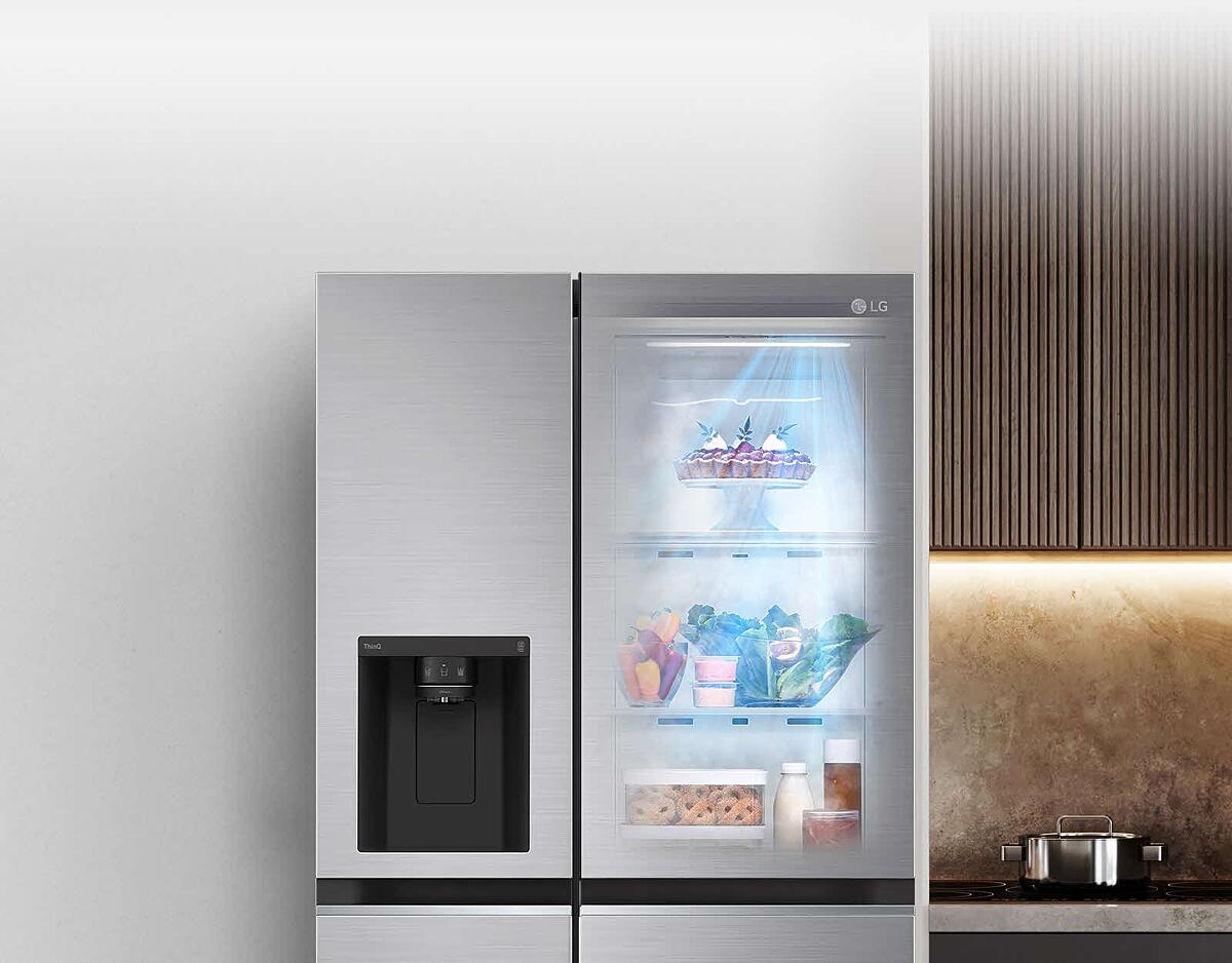 The front view of a black InstaView refrigerator with the light on inside. The contents of the refrigerator can be seen through the InstaView door. Blue rays of light shine down over the contents from