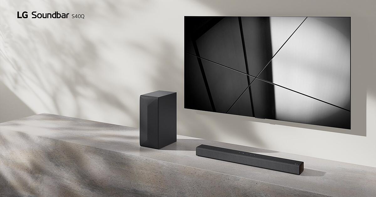 LG sound bar S40Q and LG TV are placed together in the living room. The TV is on, displaying a geometric image.