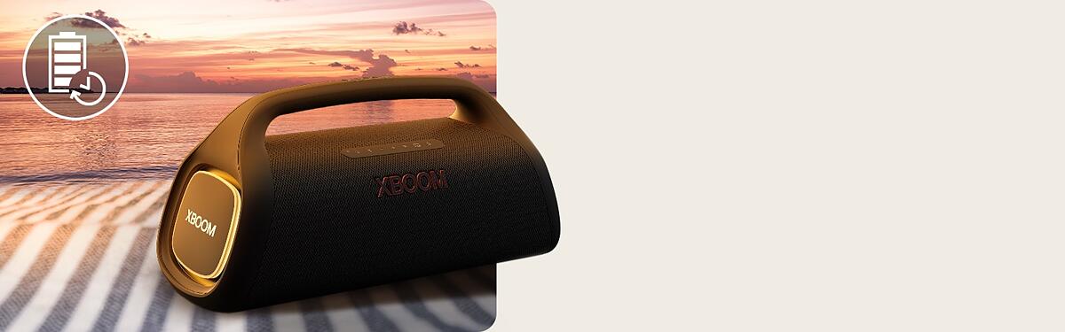 The speaker is placed on a beach towel. In front of the speaker, it shows sunset beach to illustrate that this speaker can be played longer.