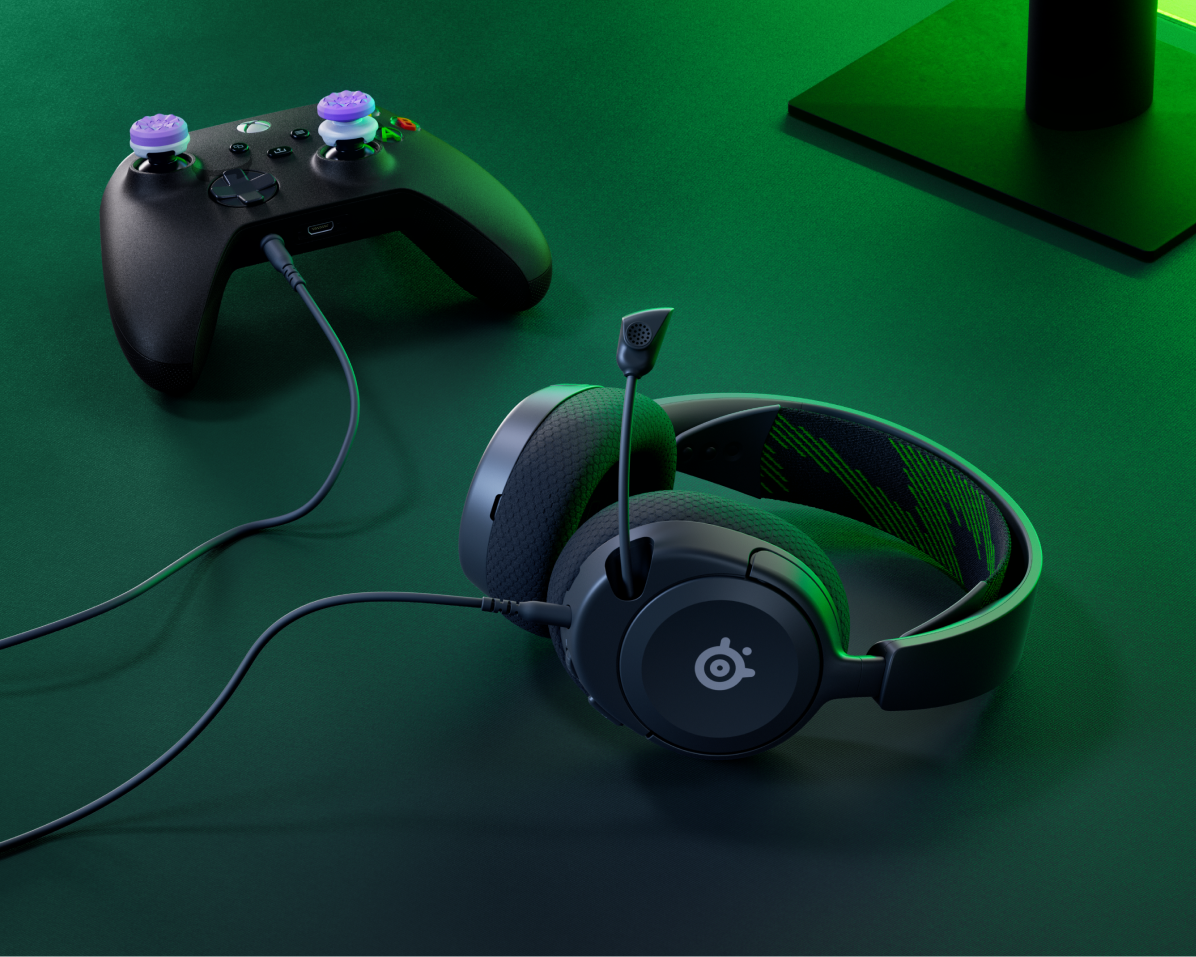 An Arctis Nova headset against a gaming setup.