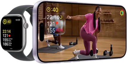 Apple Watch next to iPhone with Apple Fitness+ class on screen